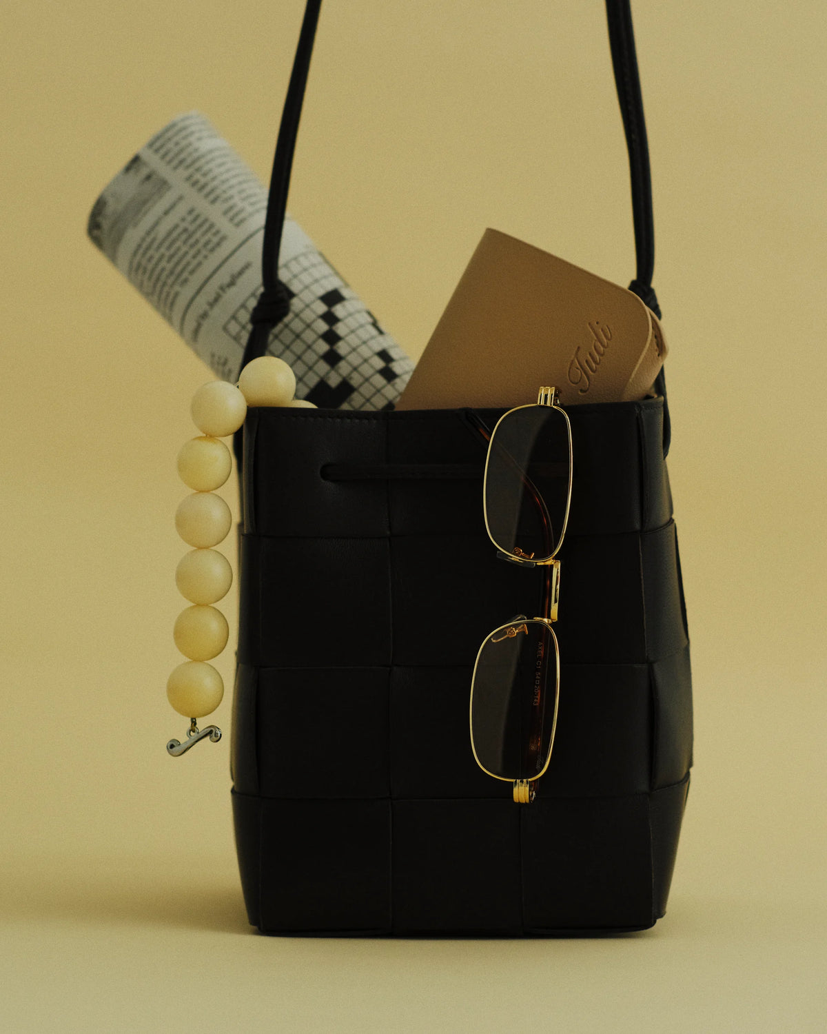 TUDI Axel eyewear, styled still life, gold metal; amber lenses