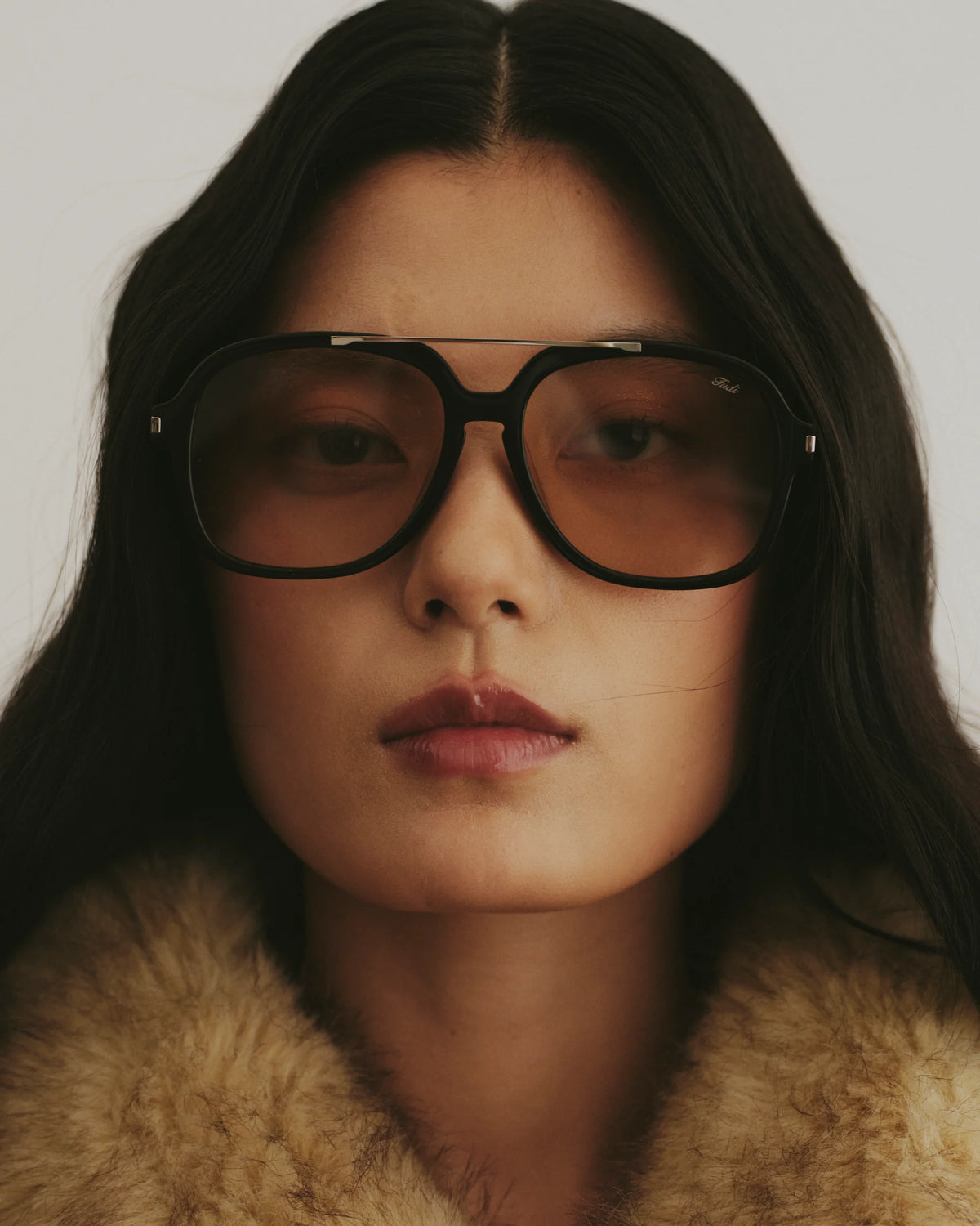 TUDI Blake eyewear, lifestyle, black frame; pale tinted lenses
