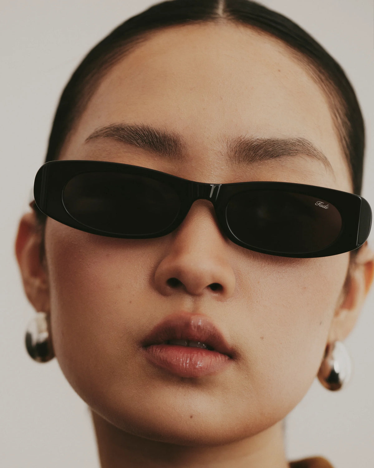 TUDI Kai eyewear, lifestyle, black frame; dark lenses
