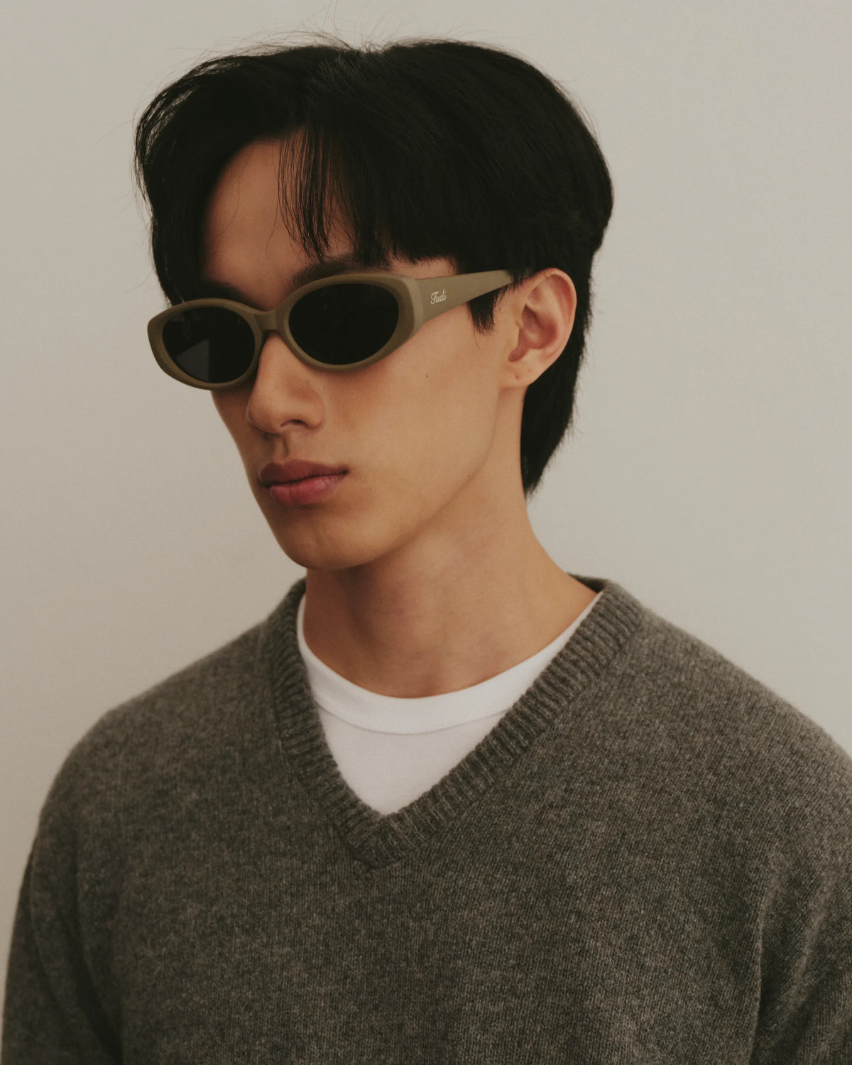 TUDI Leone eyewear, lifestyle, khaki frame; dark lenses