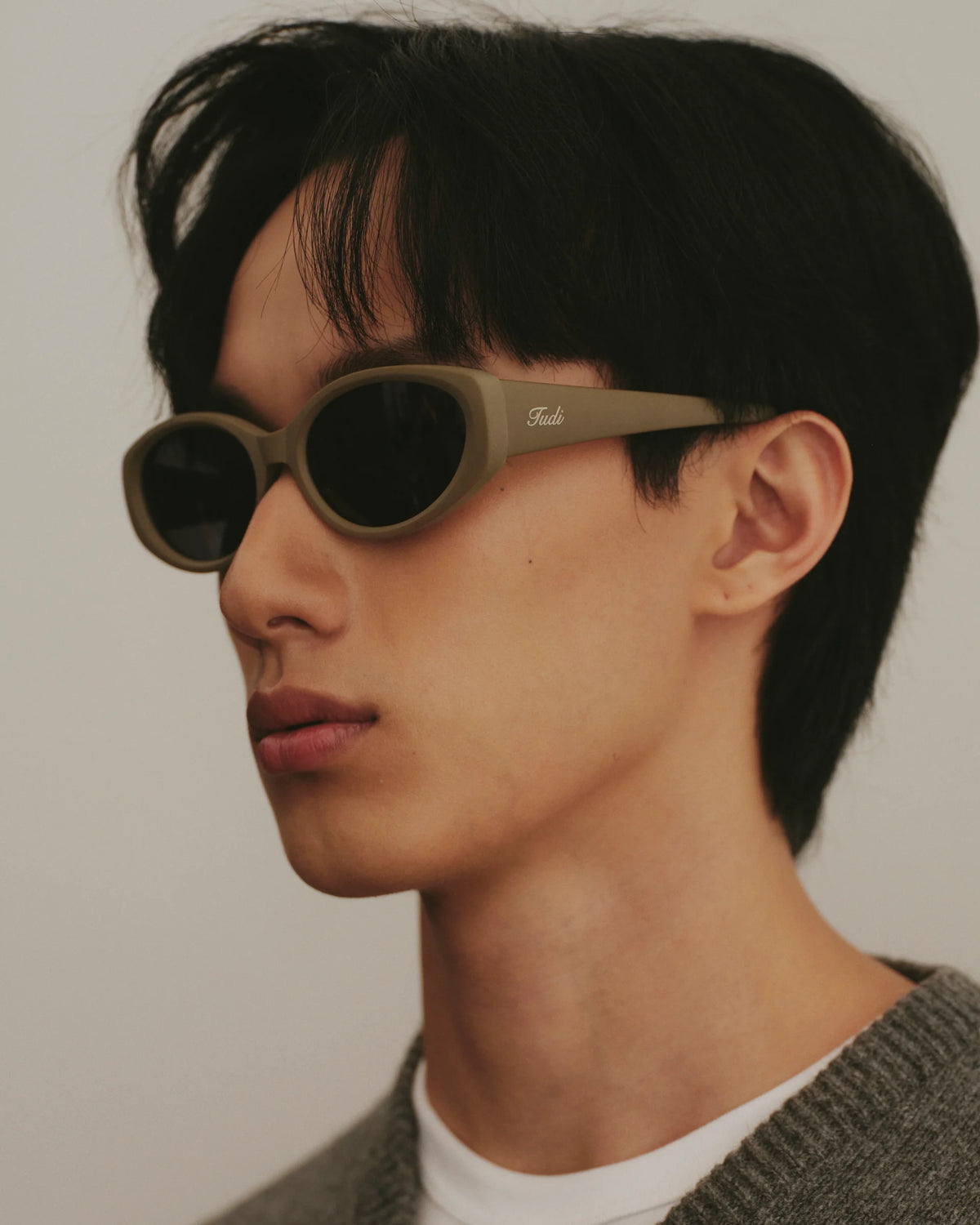 TUDI Leone eyewear, lifestyle, khaki frame; dark lenses