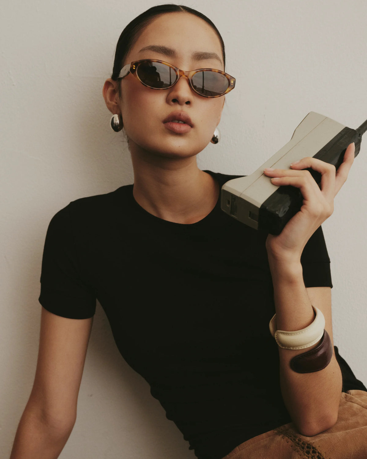 TUDI Mabel eyewear, lifestyle, amber havana frame; dark lenses