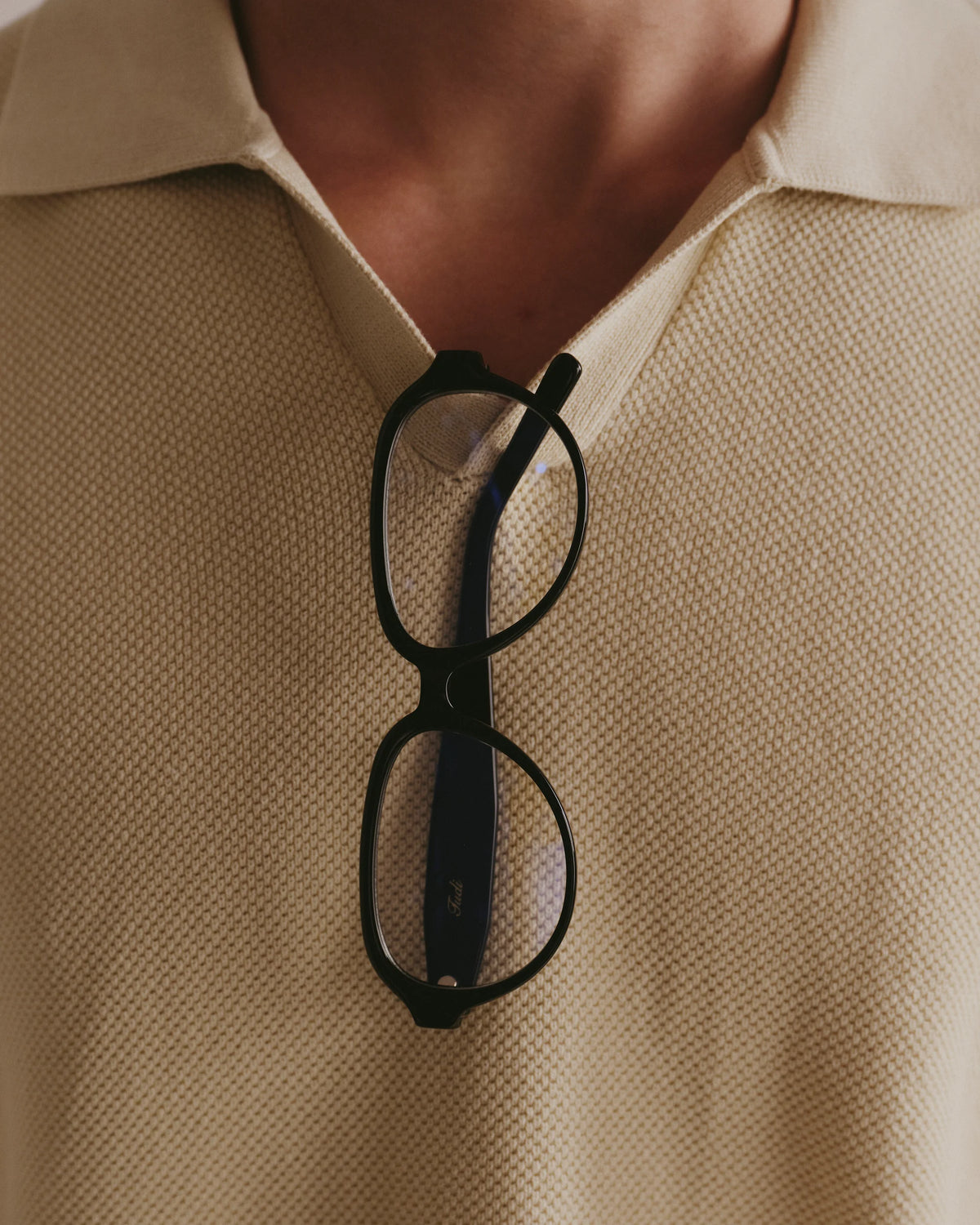 TUDI Meet eyewear, styled still life, black frame; clear lenses