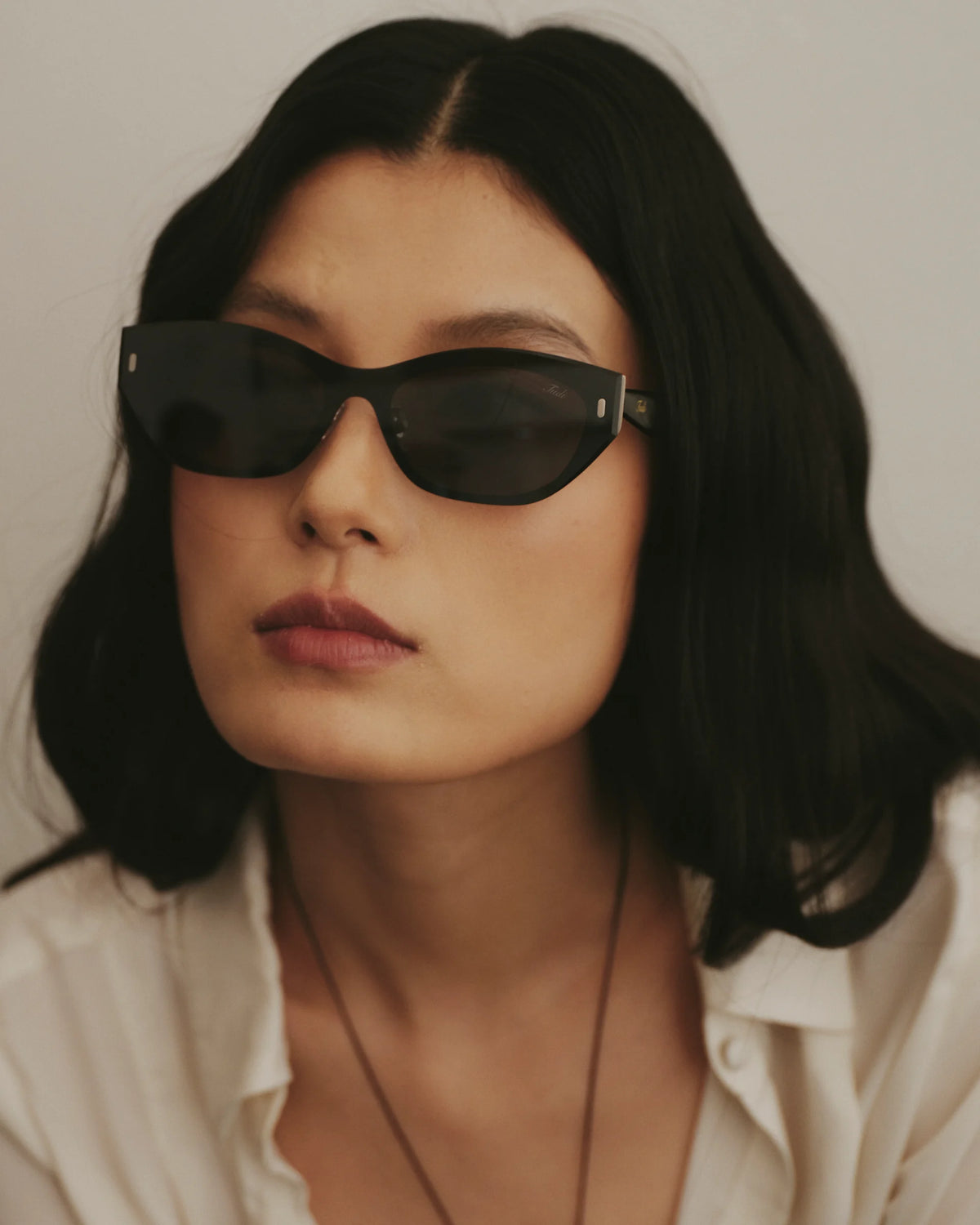 TUDI Molly eyewear, lifestyle, black front; dark lenses