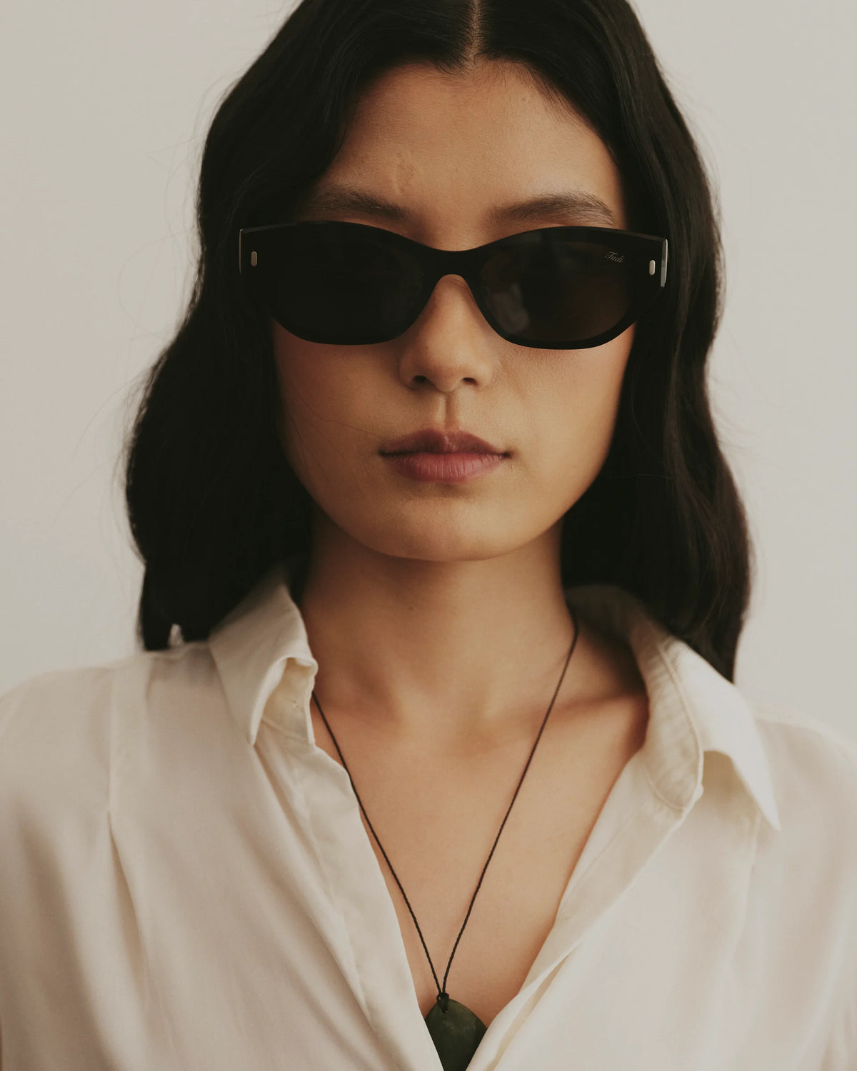 TUDI Molly eyewear, lifestyle, black front; dark lenses