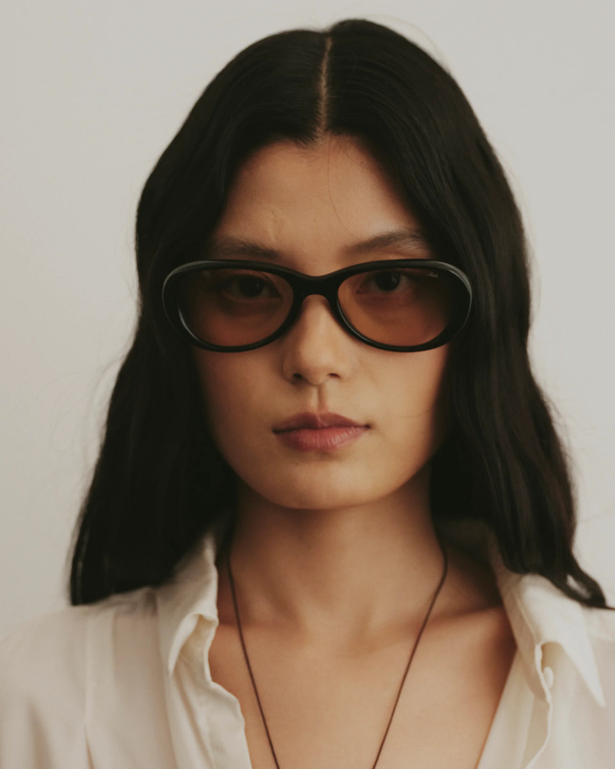TUDI Nook eyewear, lifestyle, black frame; rose-tinted lenses