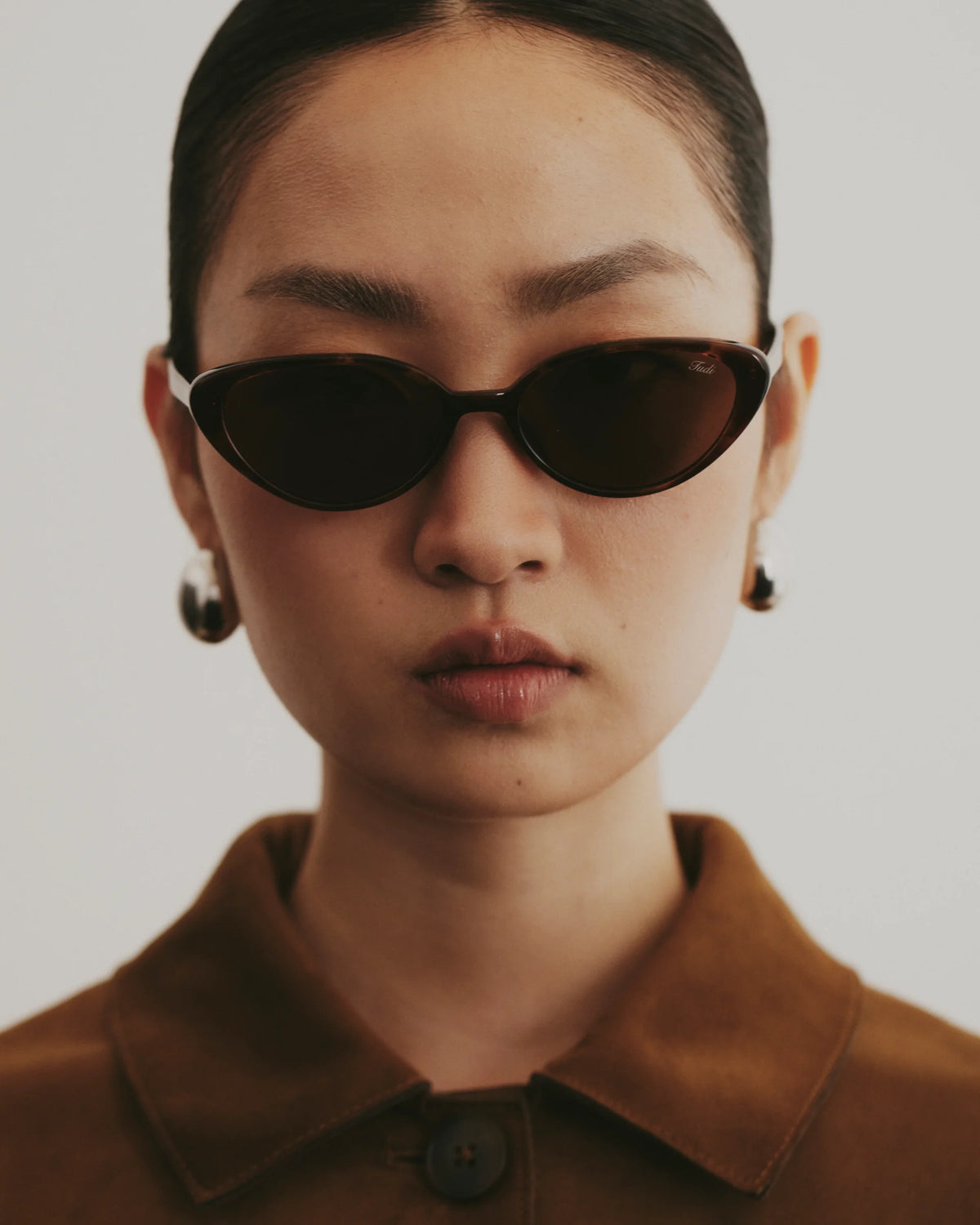 TUDI Nuna Brown tortoiseshell frame; dark lenses eyewear, lifestyle