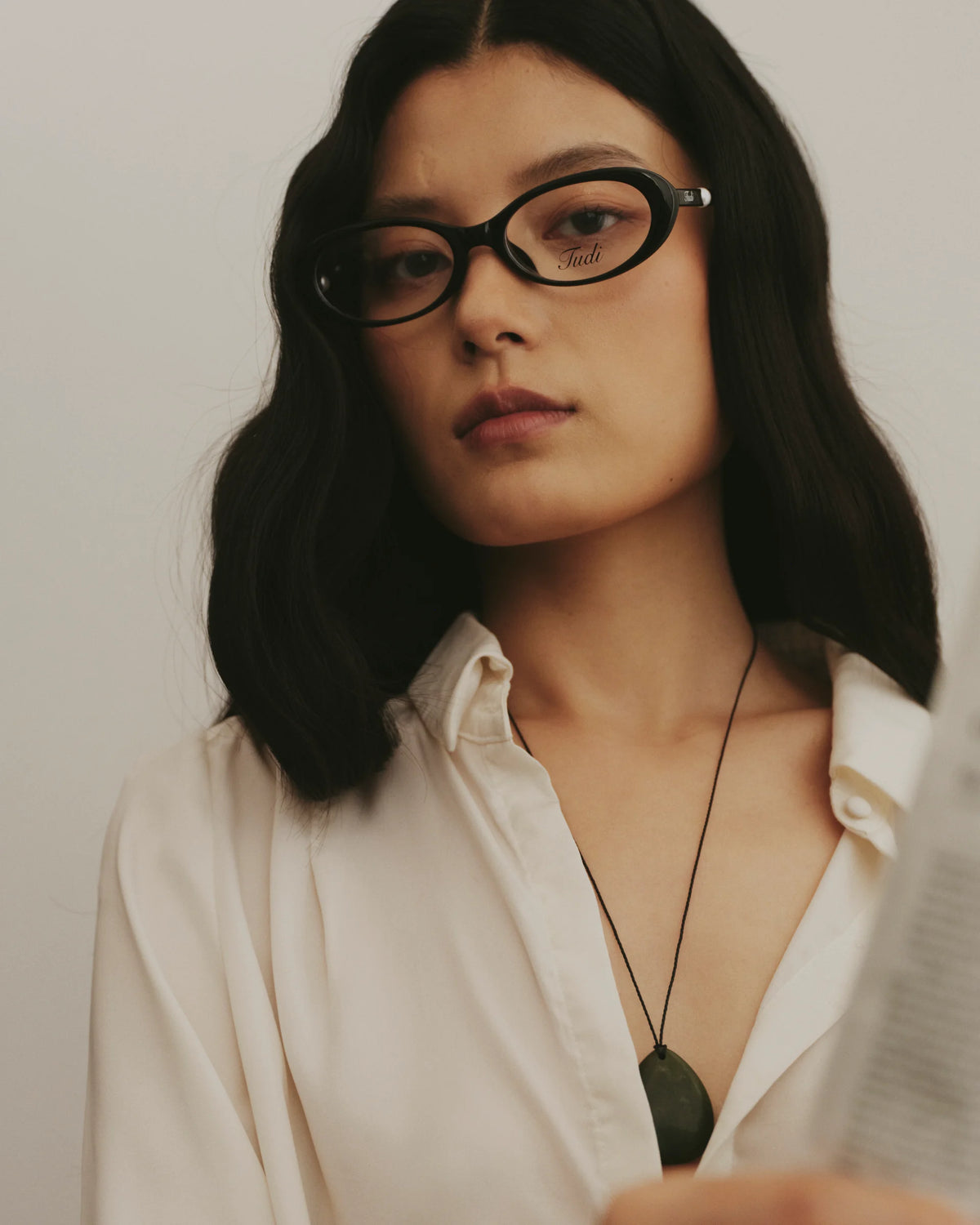 TUDI Pearl eyewear, lifestyle, black frame; clear lenses