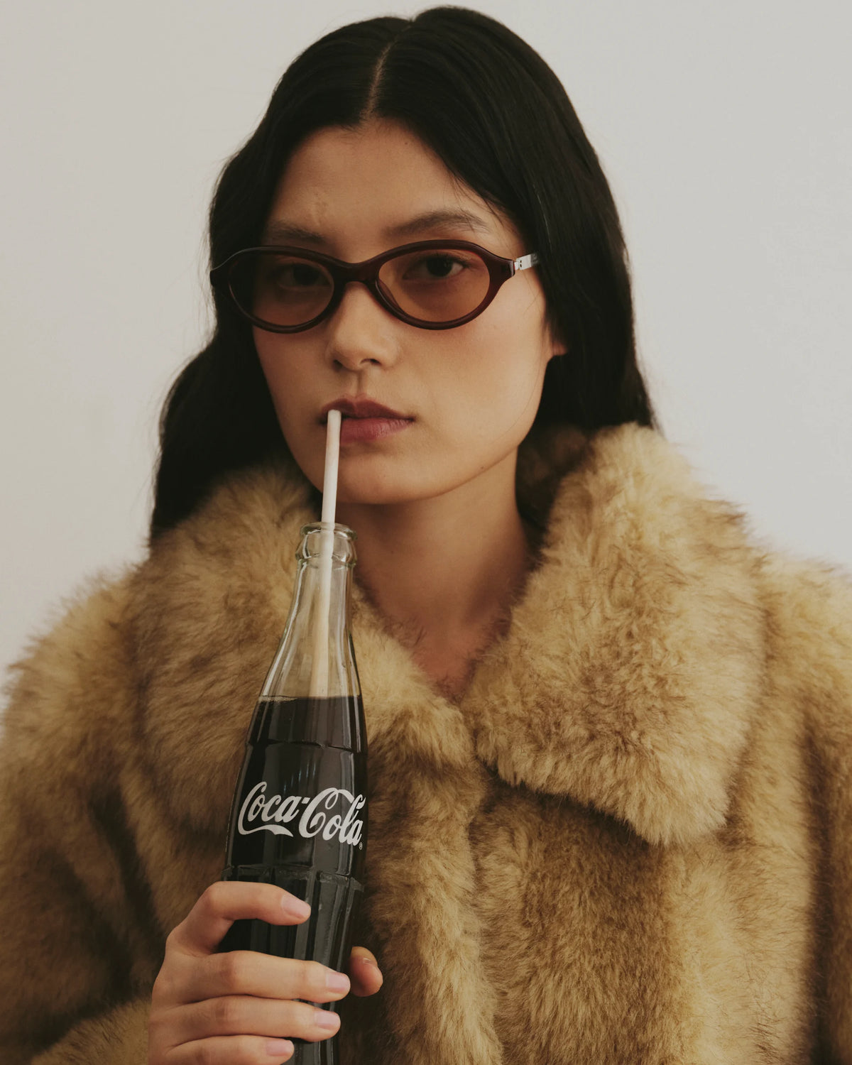 TUDI Riko eyewear, lifestyle, wine-red frame; rose-tinted lenses